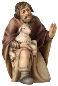 Shepherd kneeling with sheep