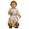 Infant Jesus sitting on manger