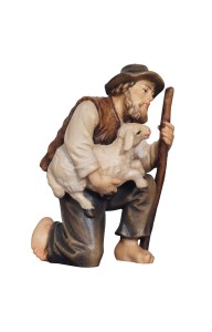 RA Shepherd kneeling with lamb in his arms